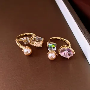 Elegant gold-plated open rings featuring faceted crystals and lustrous pink pearls