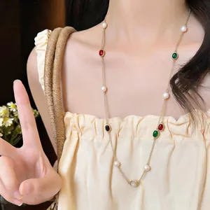 Elegant long layering necklace with oval colorful zircons and white freshwater pearls shown on model