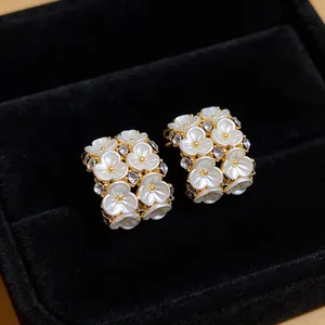 Detailed macro view of French style floral earrings with zircons in a black jewelry box