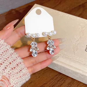 Detailed close-up view of elegant French style pearl and marquise-cut zircon dangle earrings