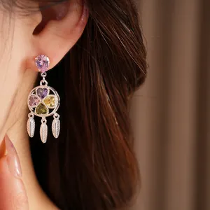 Detailed view of vintage palace style earrings with colorful zircon flower and tassels