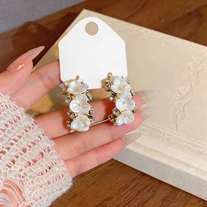 Close-up of elegant French style flower hoop earrings with sparkling zircon accents