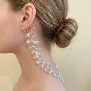 Elegant multi-layer cascading pearl ear cuff with silver chains for a minimalist look.