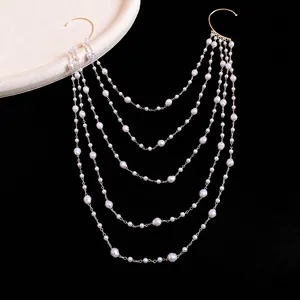 Elegant multi-layer pearl beaded ear cuff earring with gold chains on black background