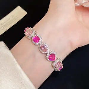 Nahaufnahme eines Luxusarmbands mit rosa Zirkonia in Herzform am Handgelenk