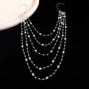 Detailed view of the layered pearl chain structure on the elegant silver ear wrap.
