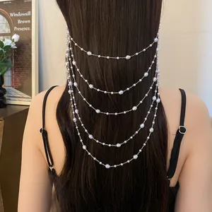 Detailed view of elegant multi-layered pearl chain hair jewelry worn on long dark hair