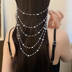 Back view of elegant multi-layer pearl headpiece with silver chain on long dark hair