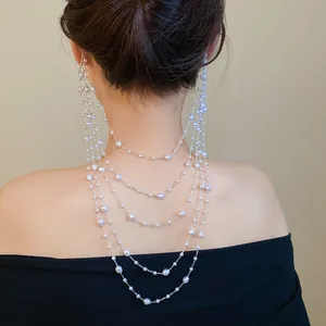 Close-up of elegant multi-layered pearl chain ear wrap draped over the back