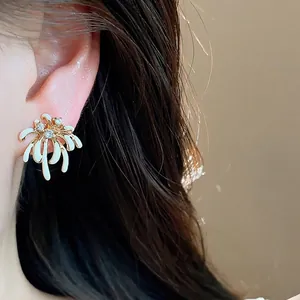 Elegant 18k gold plated zircon firework stud earrings with white enamel on model
