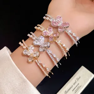 Elegant double-layer open bangles featuring zircon butterfly designs in pink and clear stones.