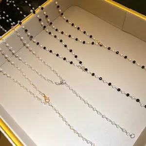 Elegant handmade beaded pearl necklaces with black and white accents in a luxury display tray.