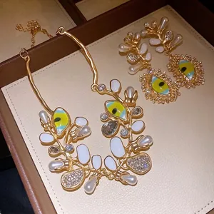 Luxury gold-plated jewelry set with evil eye enamel charms, pearls and rhinestones