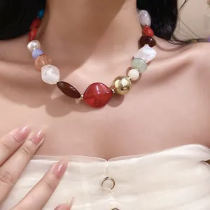 Bohemian style necklace featuring multicolor irregular resin beads shown on a model