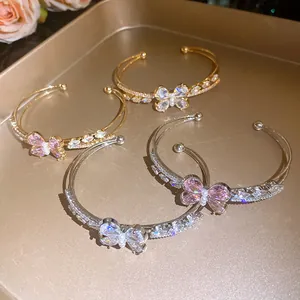 Detailed view of elegant double-layer butterfly cuff bracelets with sparkling zircons.