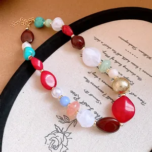 Close-up detail of vibrant bohemian colorful irregular resin bead necklace with gold accents