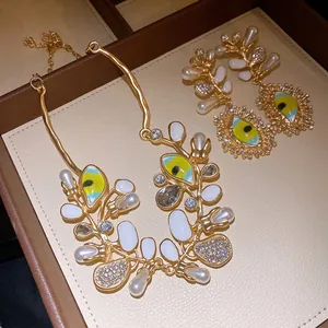Luxury gold-plated evil eye necklace and earrings set with pearls and rhinestones