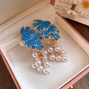Elegant vintage blue enamel maple leaf and pearl cluster drop earrings presented in a gift box