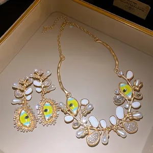 Statement jewelry set with enamel evil eye motifs, pearls and rhinestones in display tray