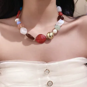 Close-up of a bohemian irregular colorful resin beaded necklace on an elegant neck