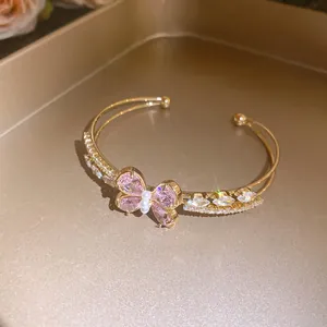 Elegant double-layer gold bangle with pink zircon butterfly and pearl detail view