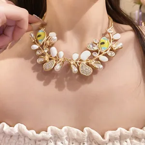 Close-up of elegant gold necklace with pearls and crystal-set eye motifs