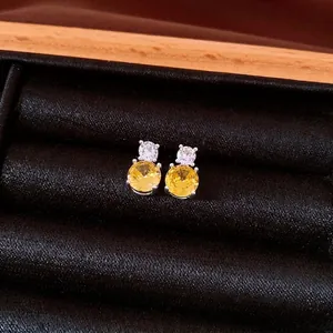 Vintage silver needle stud earrings with round yellow and clear zircons