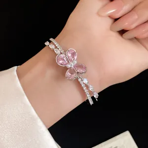 Elegant pink zircon butterfly double-layered open bracelet detail view on model wrist