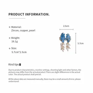 Close-up detail of blue grape-shaped pearl earrings showing materials and dimensions