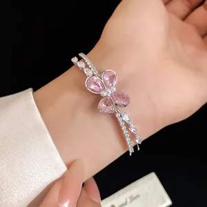 Exquisite silver-tone open bangle featuring a pink zircon butterfly on a model's wrist