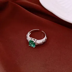 Elegant vintage-style silver open ring featuring a radiant emerald-cut green zircon center