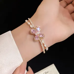 Close-up of elegant double-layered bracelet with pink zirconia butterfly motif
