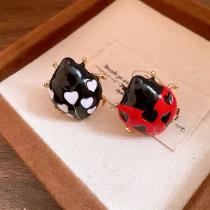 Elegant enamel ladybug open rings with heart patterns on a premium jewelry display box