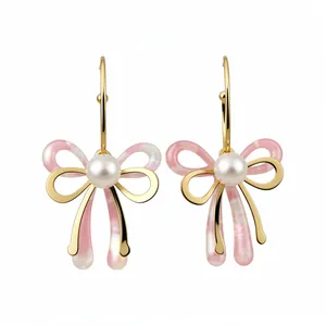 Elegant gold-tone pearl bow pendant earrings with pink acetate details for women