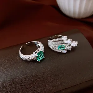 Detail shot of vintage silver rings with emerald green and clear zircon stones.