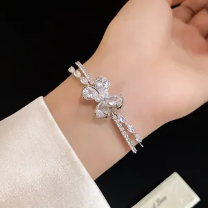 Close-up of a double-layered silver bracelet with a sparkling zircon butterfly motif.