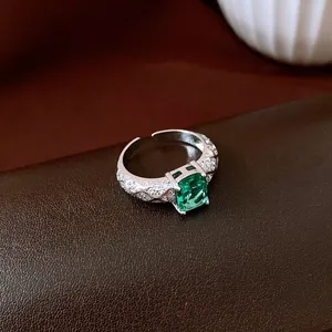 Detailed view of an elegant open ring with a rectangular green zirconia stone