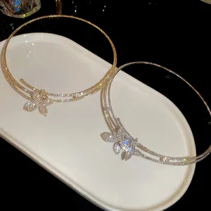 Close-up of elegant double-layered diamond-encrusted flower choker necklaces in gold and silver