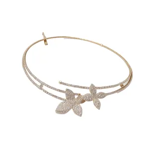 Elegant double-layer necklace featuring diamond-encrusted flower motifs on a gold band.