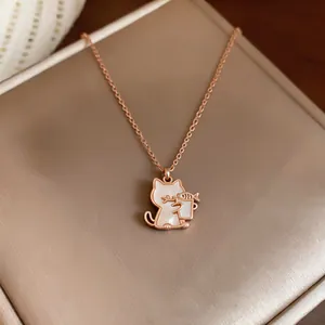 Detail view of cute rose gold cat pendant necklace featuring mother of pearl inlay