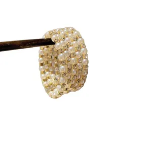 Elegant multi-row pearl and rhinestone cuff bracelet with luxury gold-plated finish design