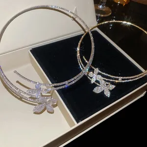 Close-up detail of double-layered rhinestone flower choker in silver and gold finish.