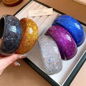 Premium colorful resin bangles featuring glitter stars displayed in a jewelry tray