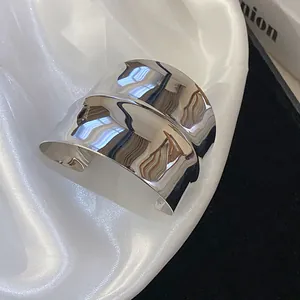 Detailed view of wide silver metallic cross hollow open cuff bracelet for women
