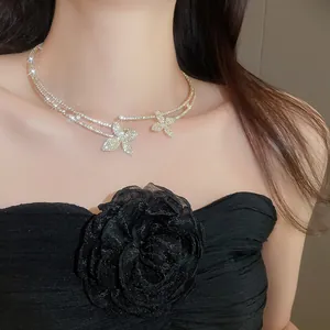 Close-up of elegant double-layered necklace with sparkling diamond butterfly pendants.