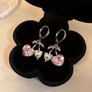 Detailed close-up of cherry heart earrings with pink resin and sparkling crystals