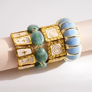Detailed view of vintage star and marbled bead elastic bracelet set on a display roll.