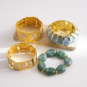 Detail view of vintage-style elastic bracelets with marble patterns and gold-tone metal