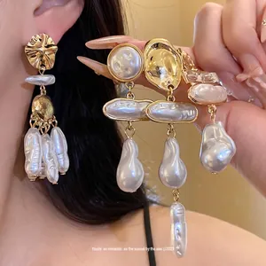 Vintage gold-toned baroque pearl drop earrings featuring an elegant irregular design
