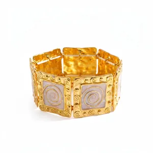 Vintage gold metal stretch bracelet with white enamel spiral pattern for women